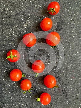 small fresh tomatoes on a board, tiny round cherry tomatoes