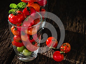 Small fresh tometo in the glass.