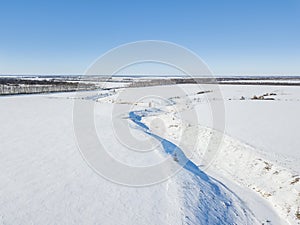 Small frozen river. Ice and snow. Aerial view landscape