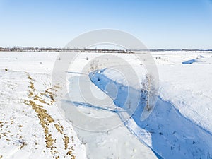 Small frozen river. Ice and snow. Aerial view landscape