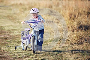 Small funny kid with bike