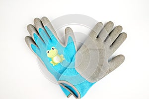 Small garden gloves. Blue gray rubberized gloves. With a frog pattern. Isolate. Copy space. Flat lay