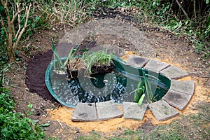A small garden pond shown under construction