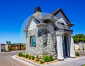 Small Gate House With Columns At Subdivision Entrance With Gates