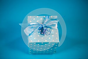 Small gift in blue wrapping, newborn, birthday