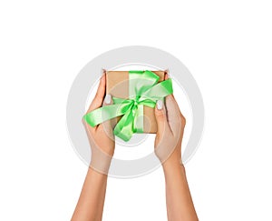 Small gift box with green bow in female hand, isolated