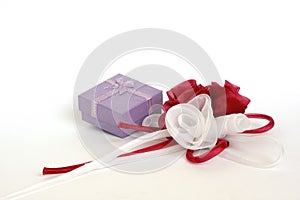 Small gift box with organdy red and white roses on white.