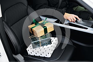 small gift boxes stand on the front seat of the car