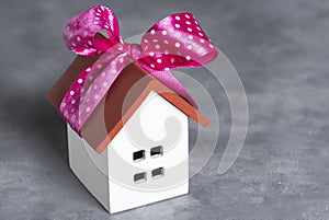 a small gift house with a pink bow