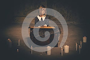 Small girl alone in old house in style of halloweeen witch