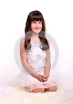 Small girl in angelic costume on white cloud