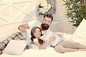 Small girl with bearded father in bed. weekend at home. father and daughter having fun. family bonding time. love my