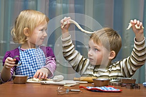 Small girl and the boy help on kitchen