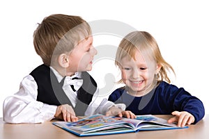 Small girl and boy read the book
