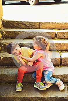 Small girl and boy on stairs. Relations. summer holiday and vacation. childhood first love. couple of little children
