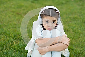 Small girl child in headphones. Childhood happiness. Mp3 player. childrens day. Audio technology. small sad kid listen