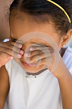 Small girl child rubbing eyes photo