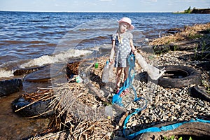 Small girl collecting rubbish