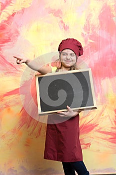 Small girl cook in hat with blackboard or chef child