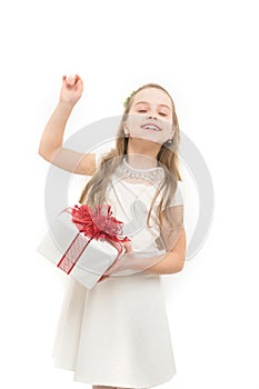 Small girl with gift box with red bow in dress.