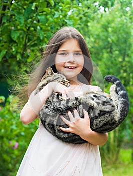 Small girl hold cute cat in hands. kid love her pet. human and animals. love and care. fluffy cat in hand of pretty