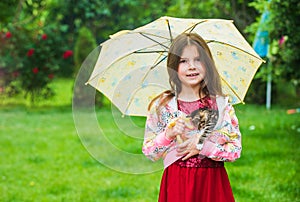 Small girl hold cute kitten. kid love her pet. human and animals. love and care. fluffy cat in hand of pretty child