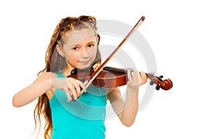 Small girl holding string and playing on violin