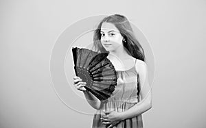 Small girl with lace black fan. fashion accessory. elegant little lady. beauty and fashion. little girl with long hair