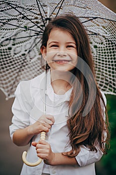 Small girl with lace umbrella