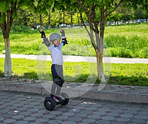 Small girl learns to ride electric mini hoverboard