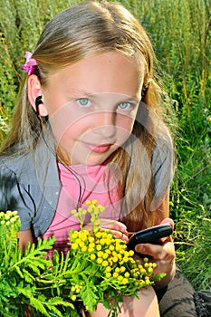 Small girl listening to music on telephone with he