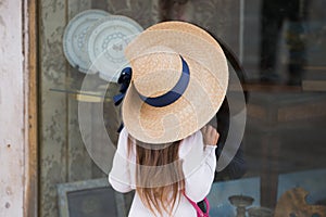 Small girl looking at shop window