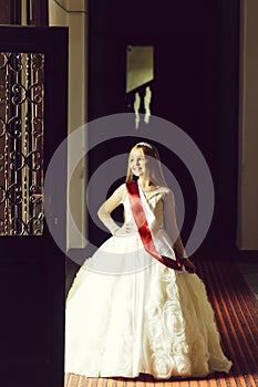 Small girl with miss ribbon in dress