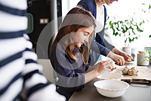 A small girl with mother and grandmother at home.