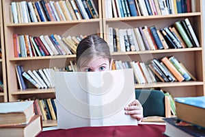 Small Girl in Old Library Reading Book