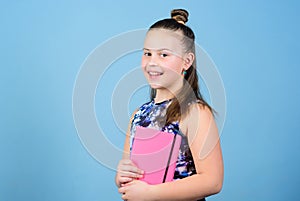 Small girl with pink note book. school child with notepad. Smart and adorable. schoolgirl ready for lesson. school