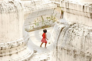 Small Girl Playing Hide and Seek at Buddhist Temple