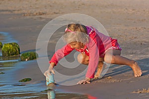 Small girl plays on the beach