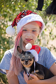Small girl in santa hat with present have a christmas. little girl in red santa hat. Girl in santa hat