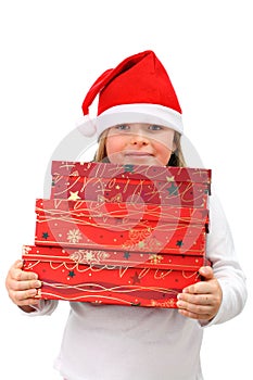 Small girl in Santa's hat carrying three presents