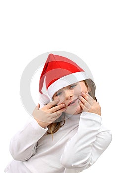 Small girl in Santa's red hat isolated on white