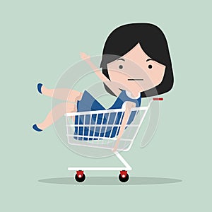 Small girl sitting in shopping cart