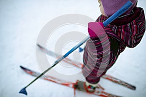A small girl is skiing on the snow