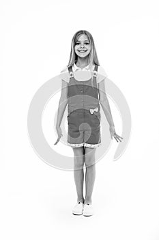 Small girl smile in pink jumpsuit isolated on white. Child smiling with long blond hair. Kid model in fashionable