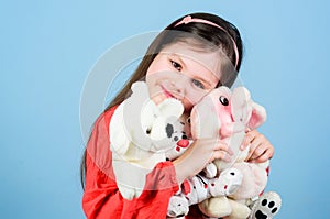 Small girl smiling face with favorite toys. Happy childhood. Little girl play with soft toy teddy bear. Sweet childhood