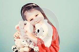 Small girl smiling face with favorite toys. Happy childhood. Little girl play with soft toy teddy bear. Sweet childhood