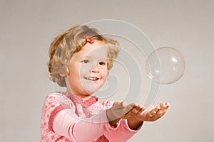 Small girl with soap bubble