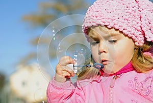 The small girl with soap bubbles