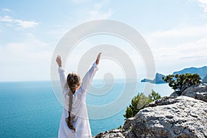 Small girl stay on the top of mountain