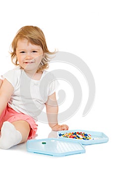 Small girl with toy mosaic